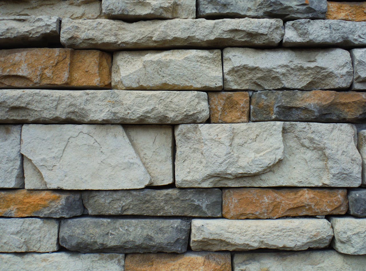 creative Close-up of a textured stone wall with a variety of natural colors.